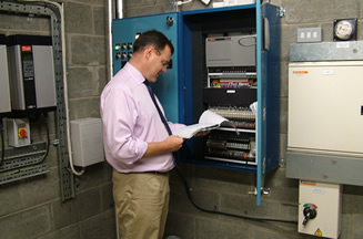Brian Hunter inspecting an Electrical Control Panel.